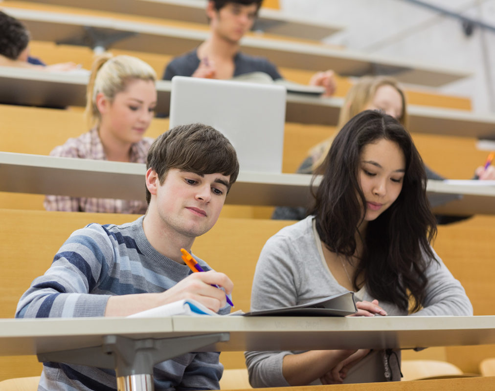 Students listening and taking notes in a lecture